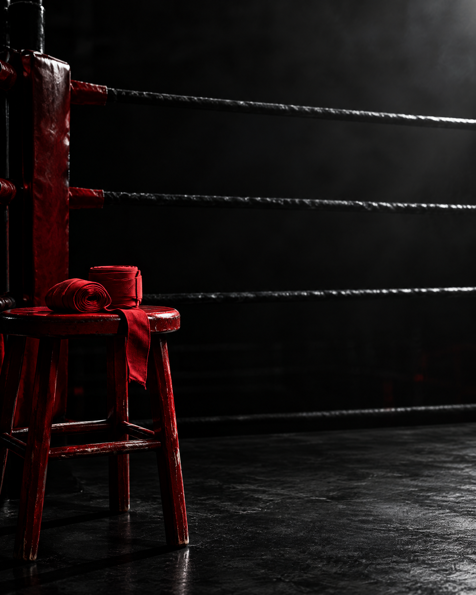 Empty Muay Thai and kickboxing ring corner with red hand wraps, representing a future competitor profile