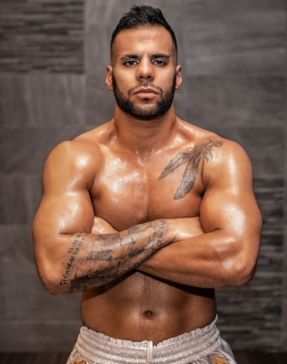 Shah Zolfaghari with folded arms in an athlete portrait